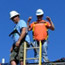 Enphase employee and GRID staffer on a roof