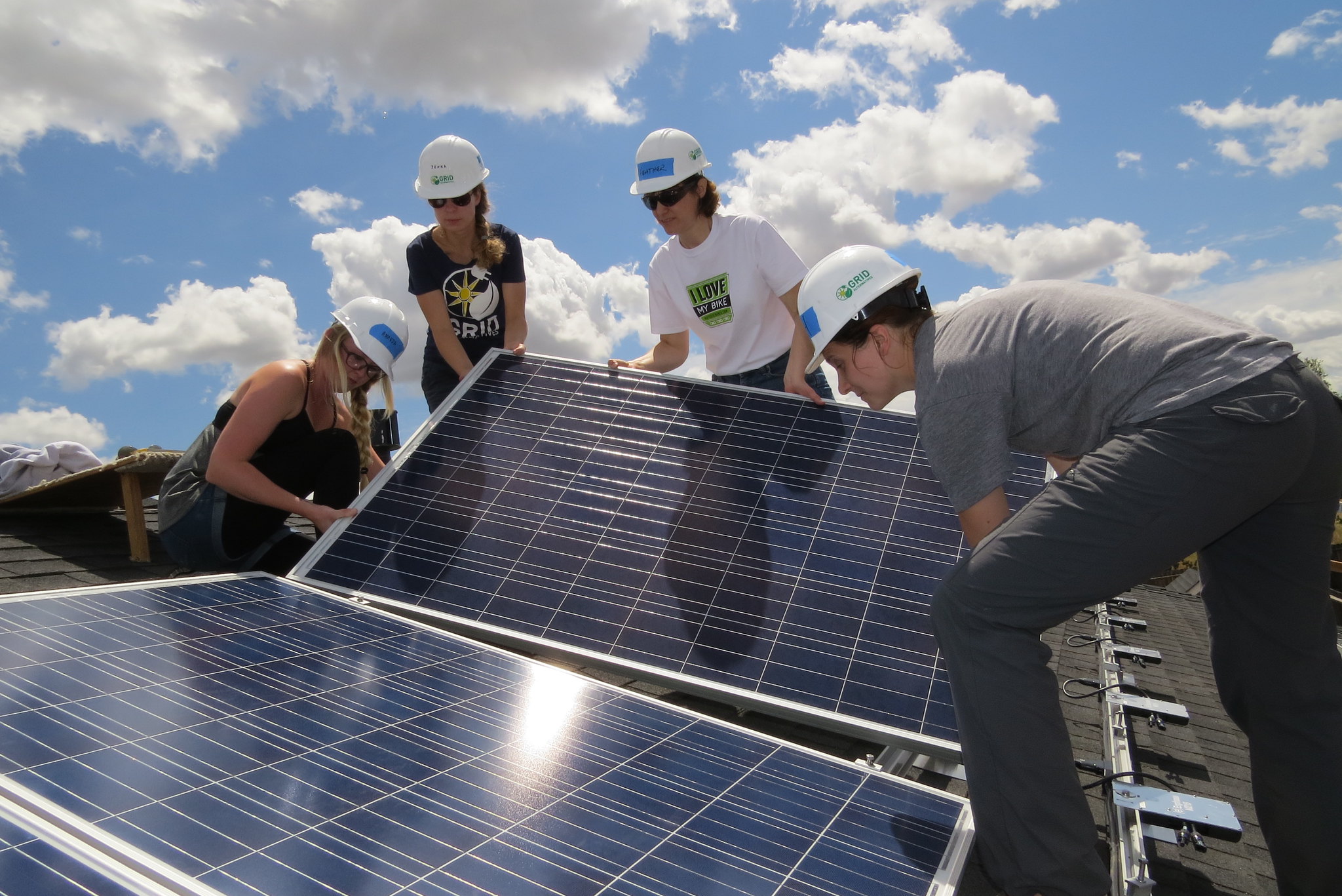 GRID installers and trainees lay panels at a large-scale site