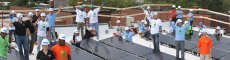 Volunteers on the roof installing solar.