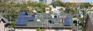 Oakland rooftop build, from a distance, showing the city skyline
