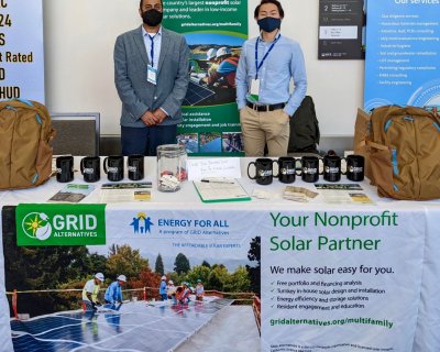 GRID staff standing at our booth for the 2022 Housing California conference.