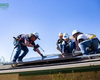 4 men on roof installing solar