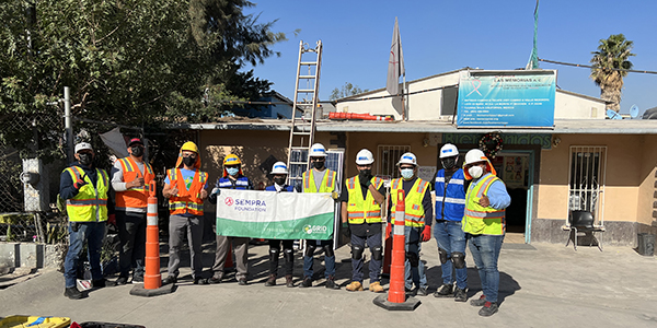 Crew at Las Memorias celebrate in front of the building